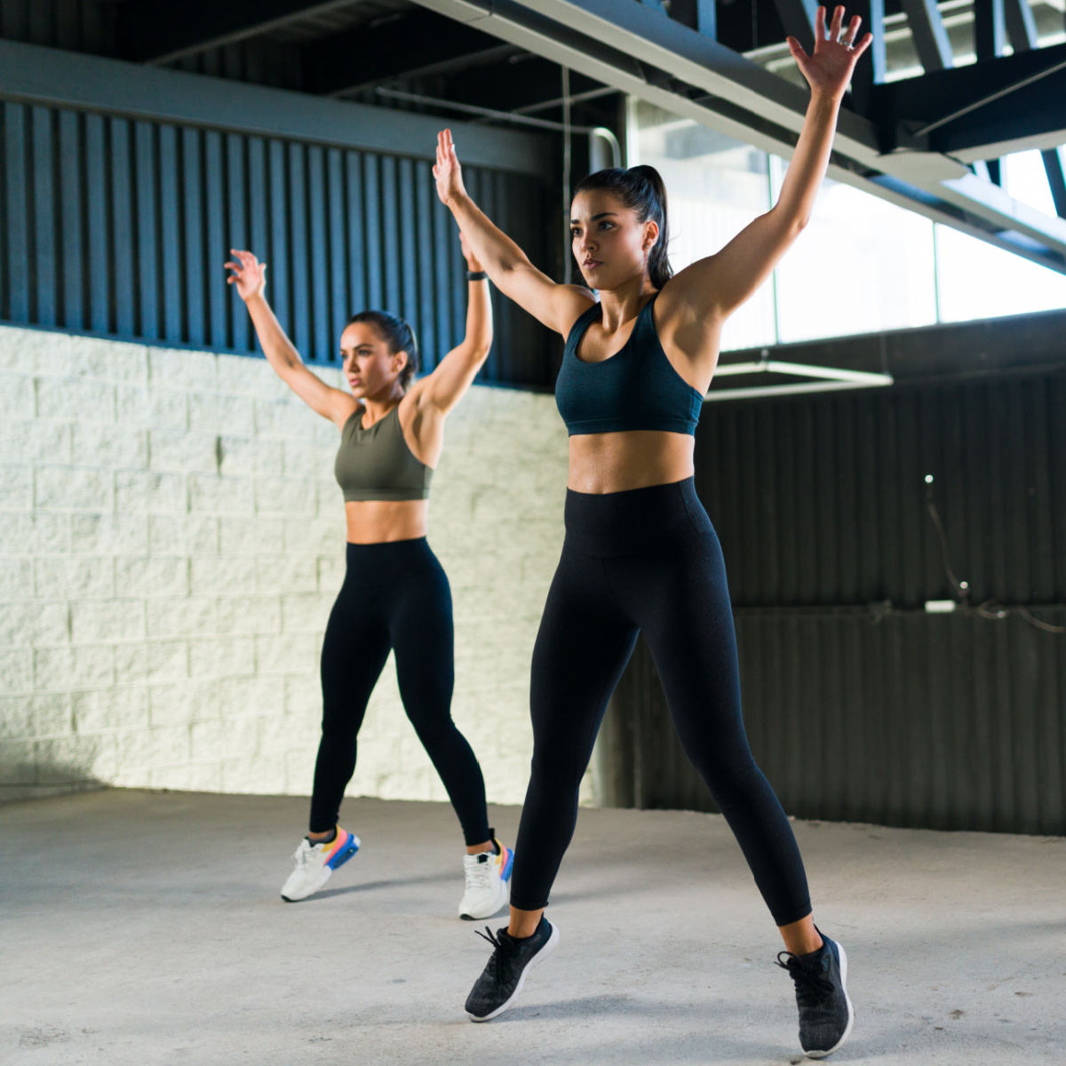 women performing HIIT workout