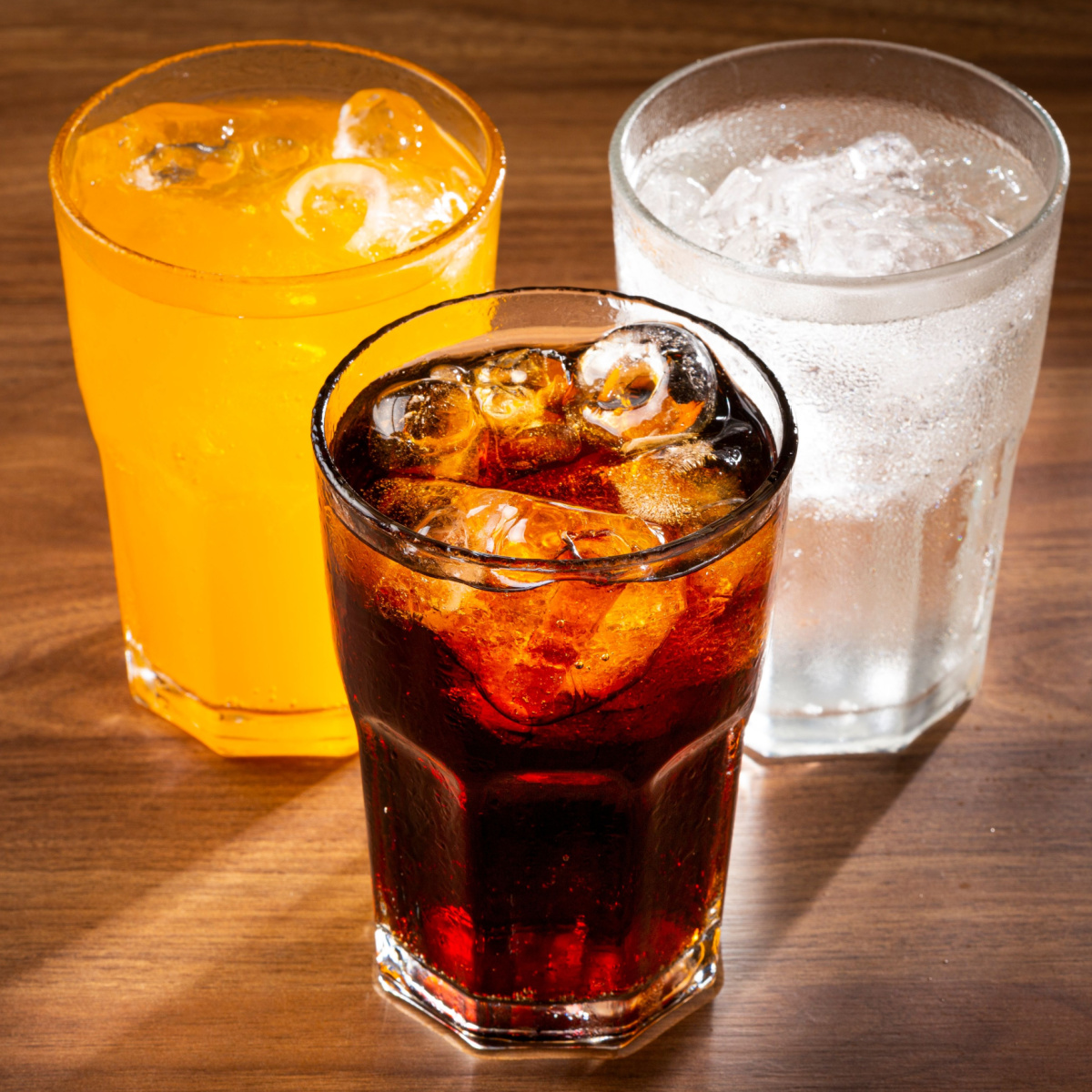 Soda and juice in glass cups