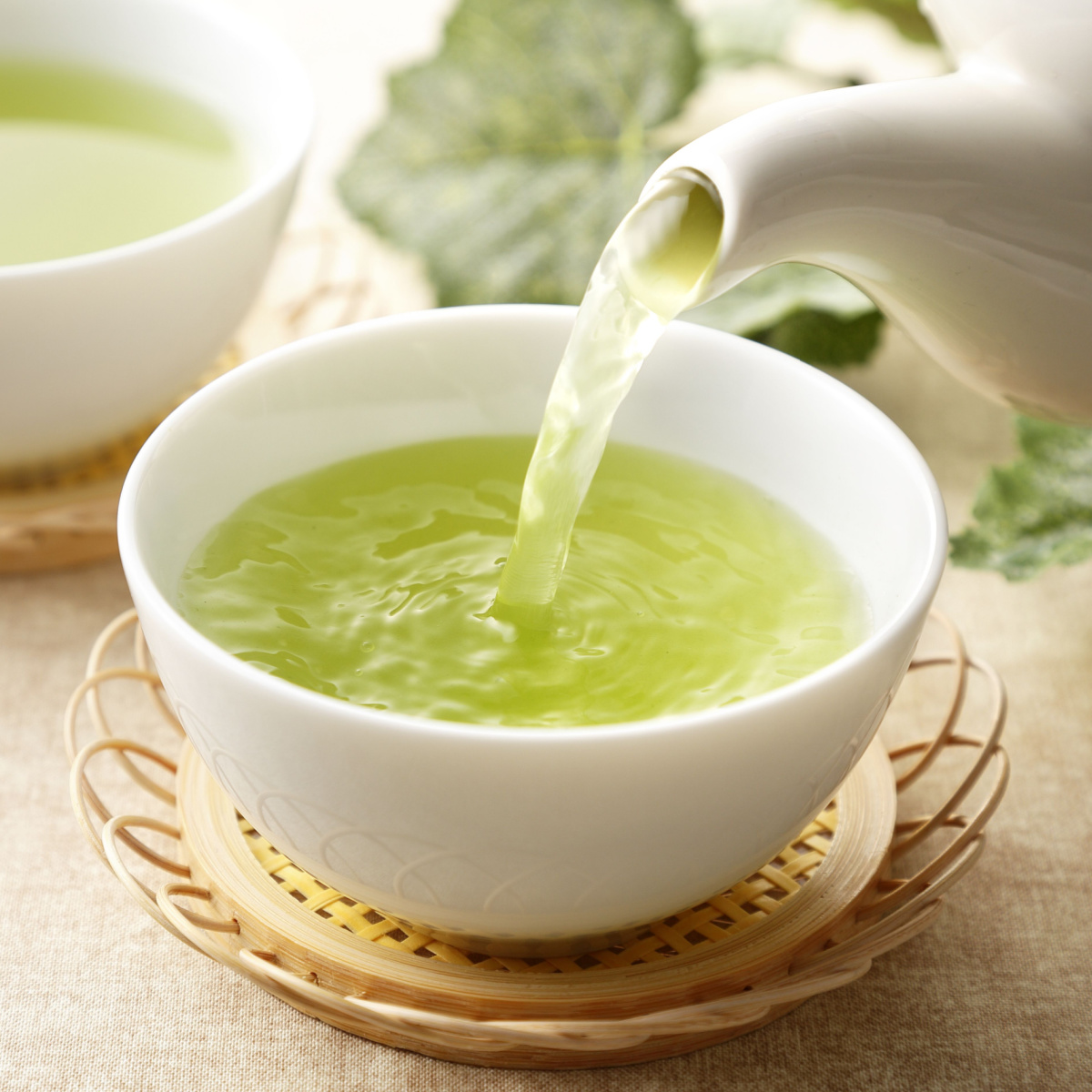 green tea pouring into a cup