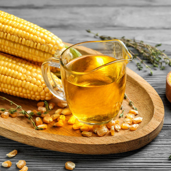 corn oil beside ears of corn