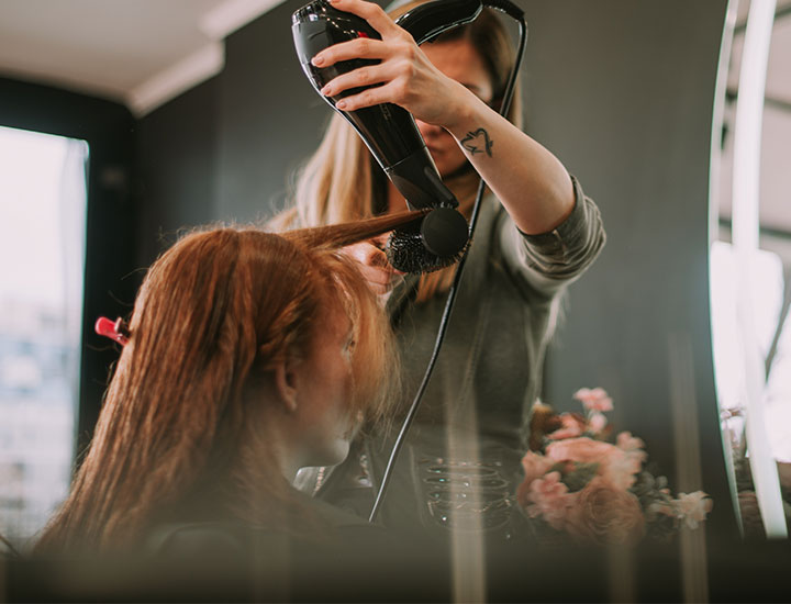 hair-stylist-drying-bangs