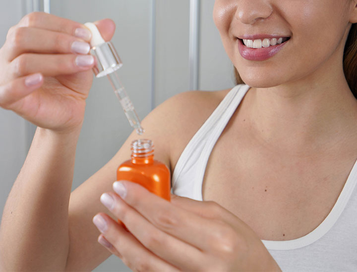 young-woman-applying-vitamin-c