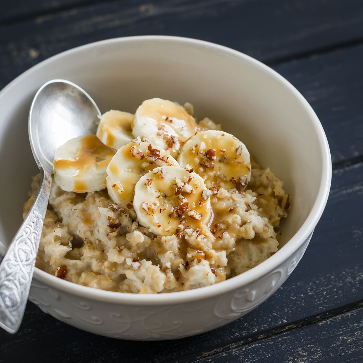 oatmeal bowl topped with bananas in white bowl