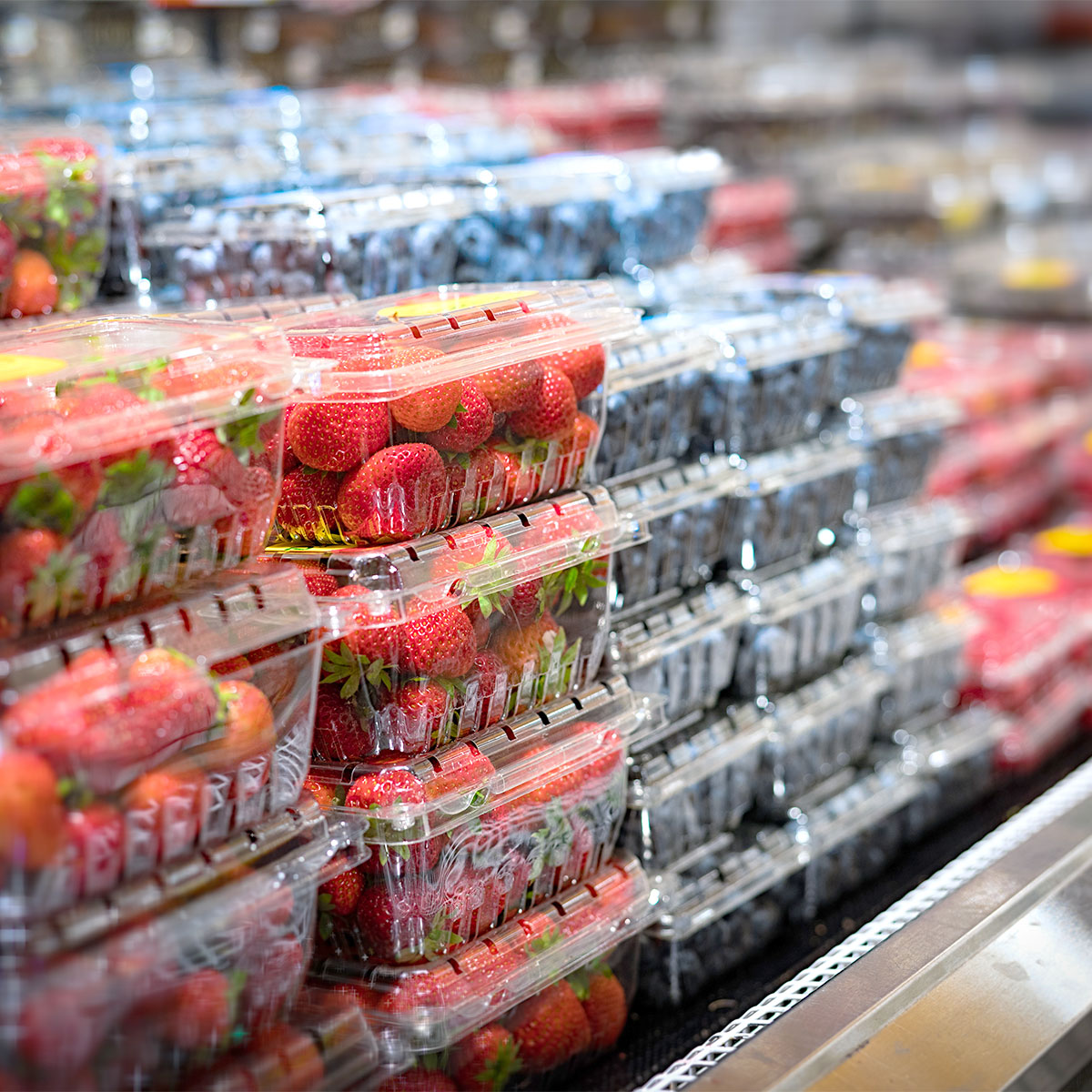 strawberries and blueberries at grocery store