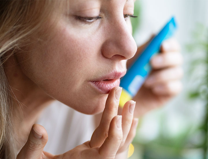 woman-applying-lip-balm