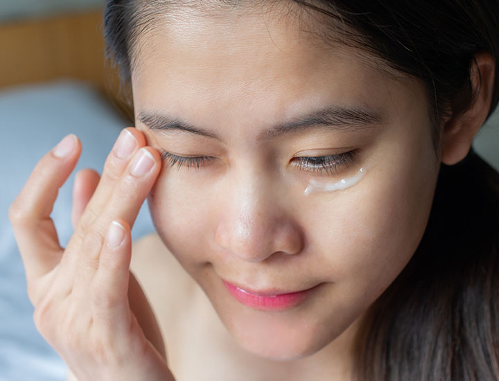 woman-rubbing-eye-cream