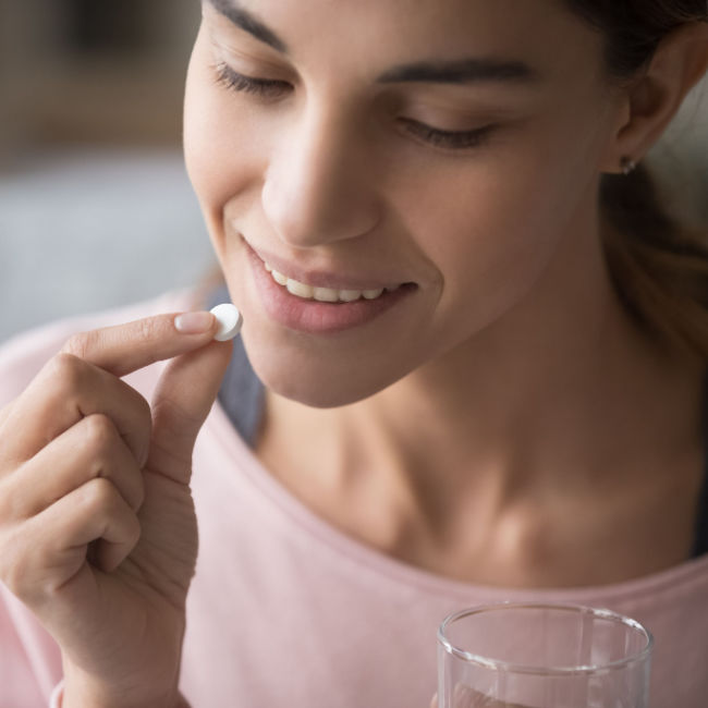 woman taking pill