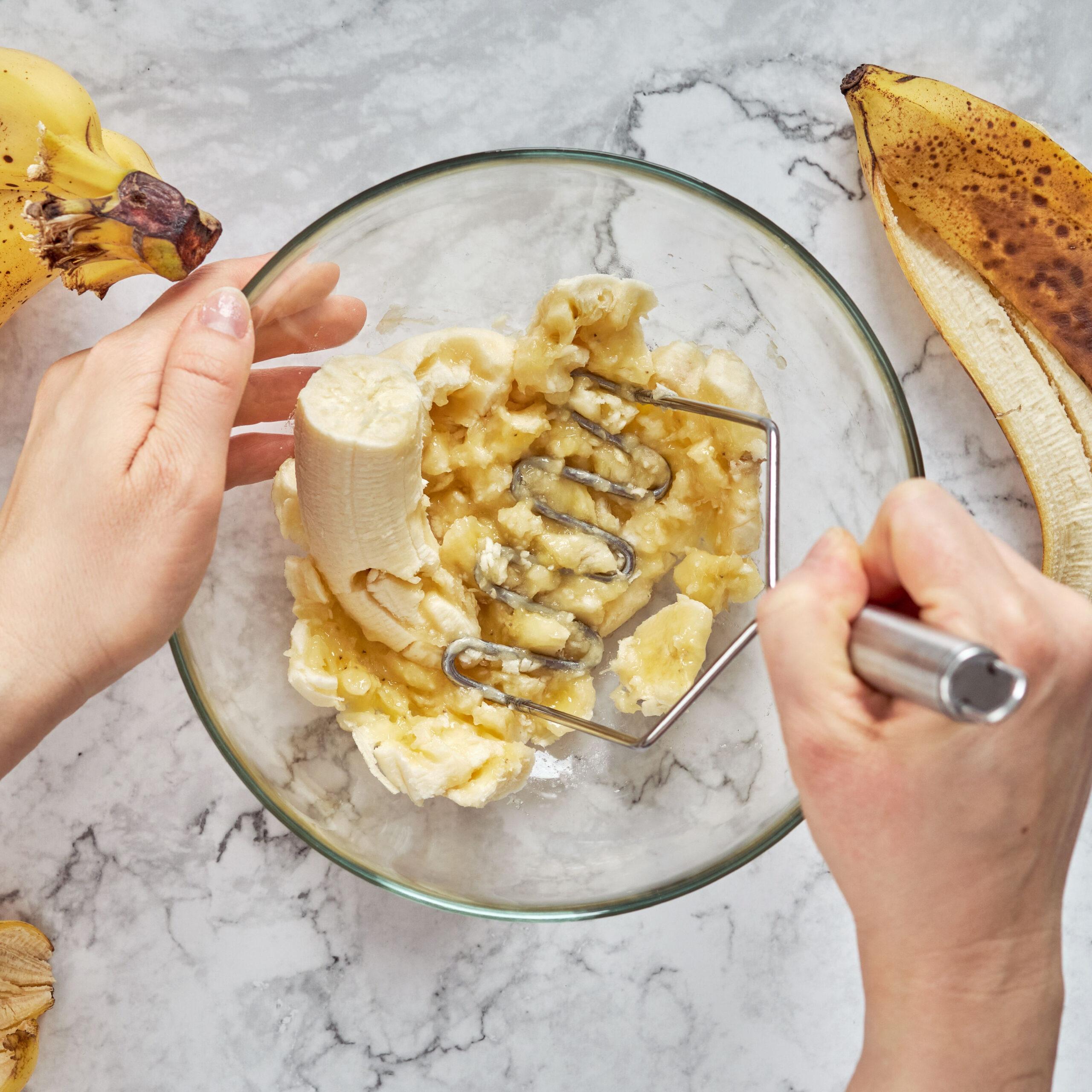 person mashing banana in bowl