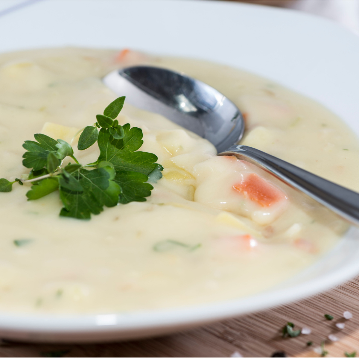 bowl of potato soup with spoon in it