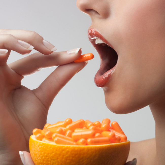 woman taking vitamin c supplement