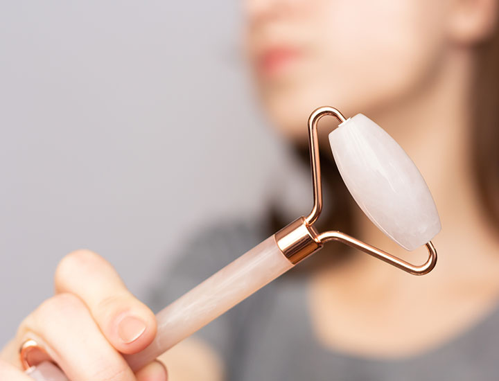 woman-using-gua-sha-roller