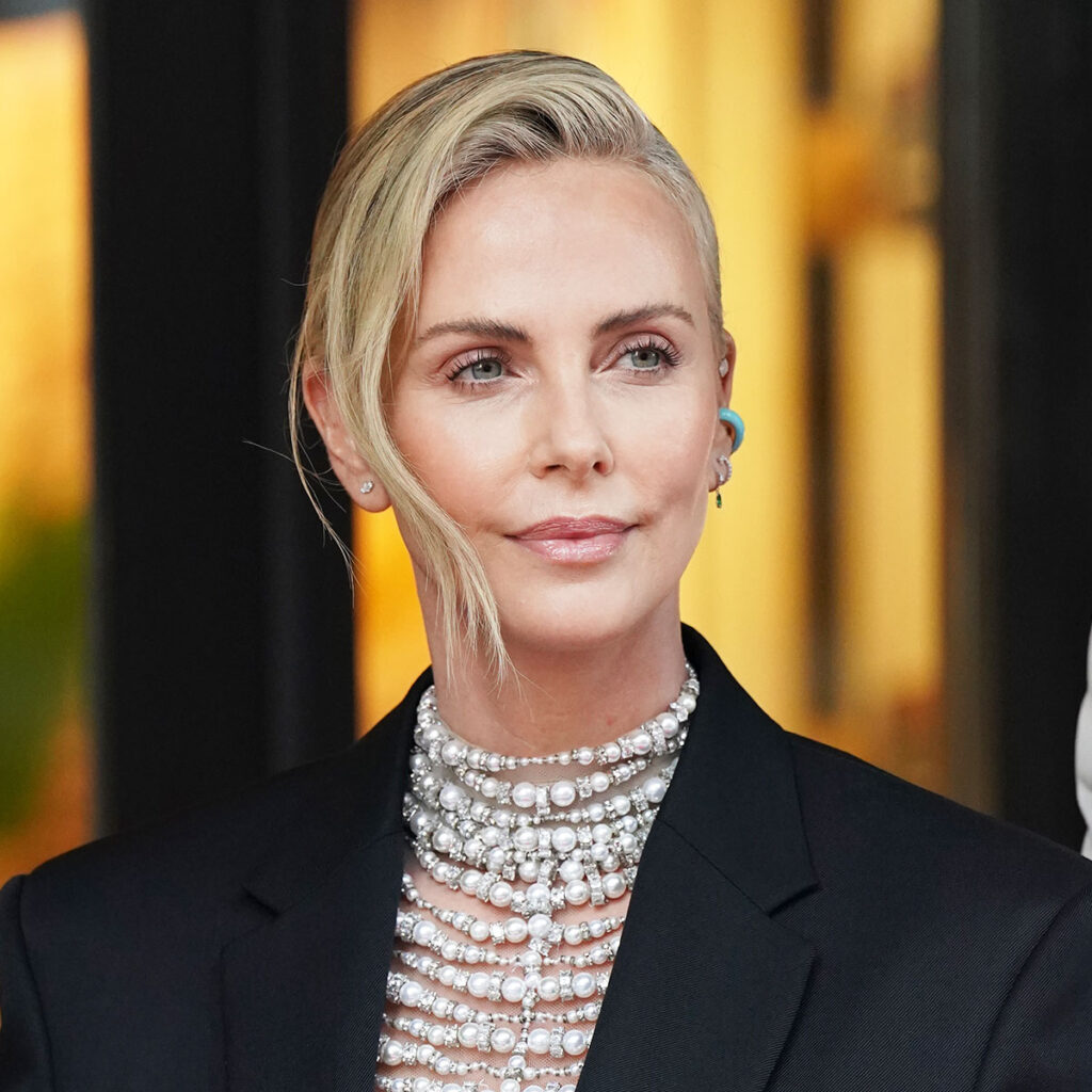 Charlize Theron Is A Show-Stopper In A Sheer Blouse & Leather Skirt For  'The Hollywood Reporter' Beauty Dinner - SHEfinds