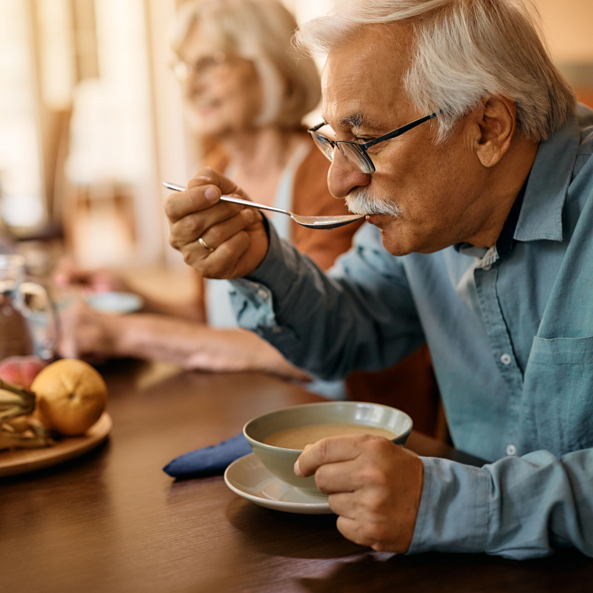 mature man drinking soup