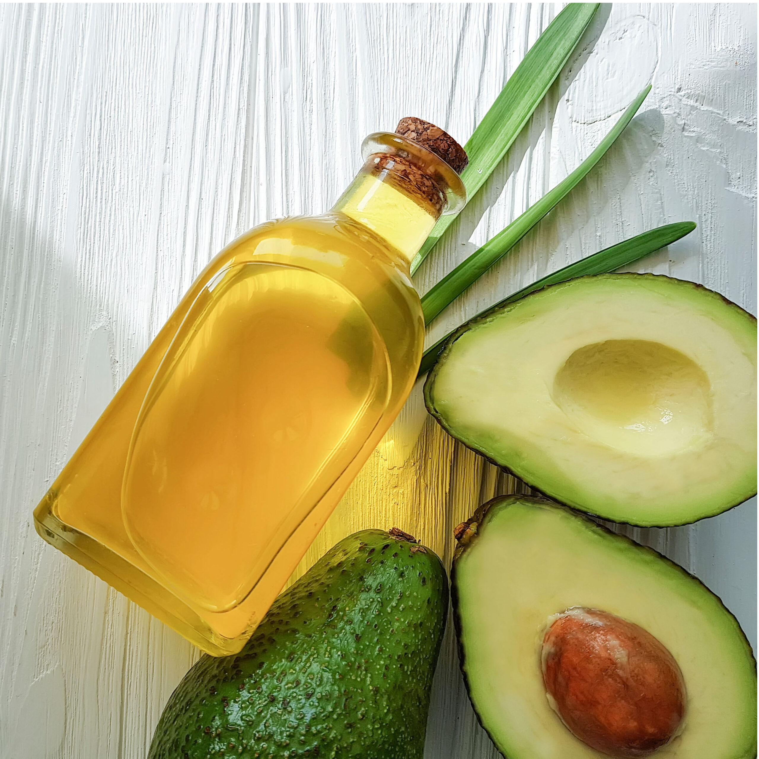 avocados and bottle of avocado oil