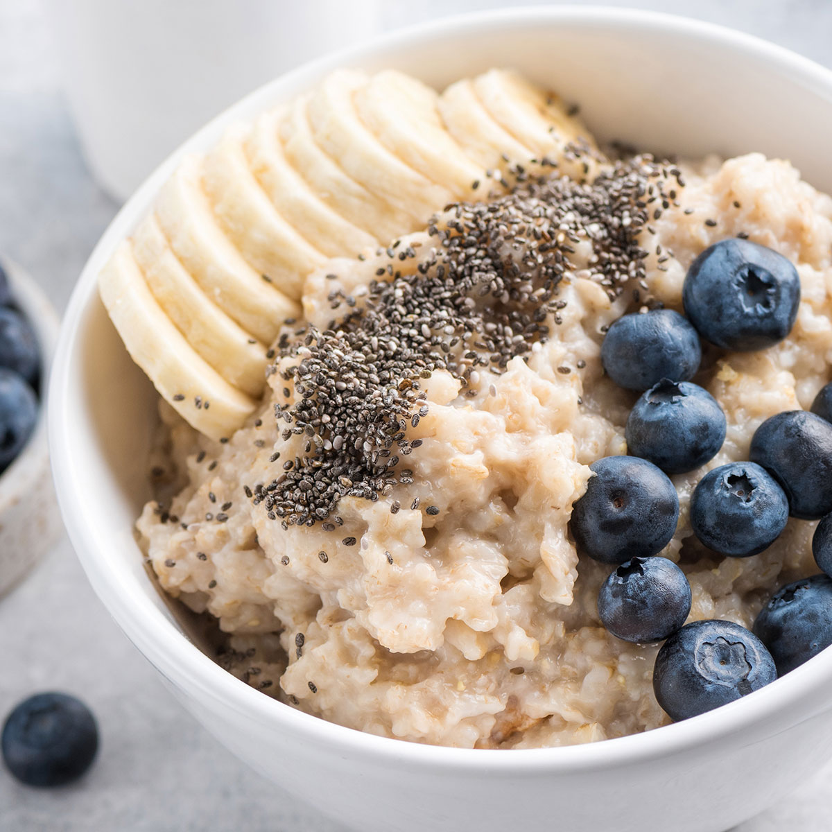 oatmeal topped with bananas, chia seeds, and blueberries