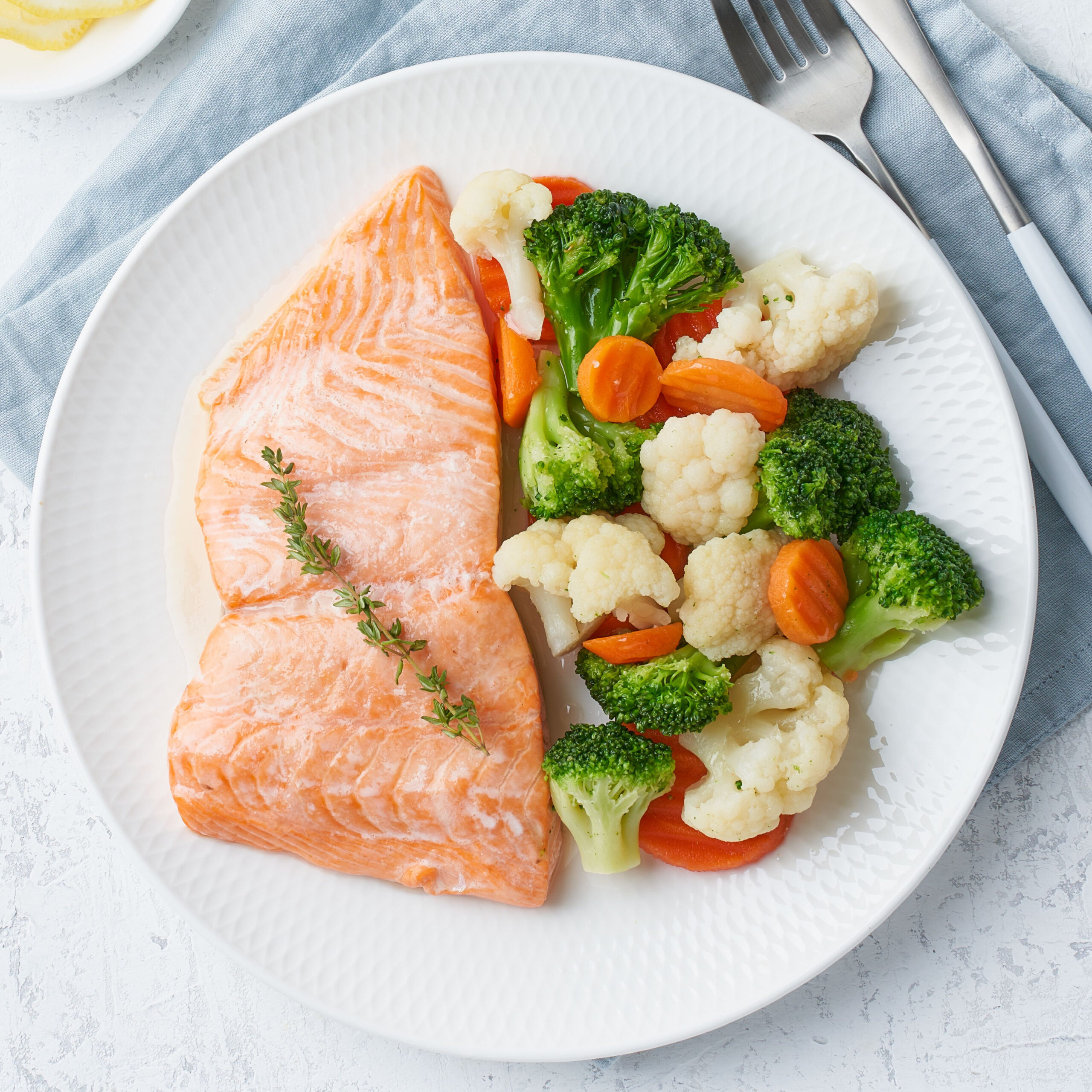 salmon and steamed veggies on plate