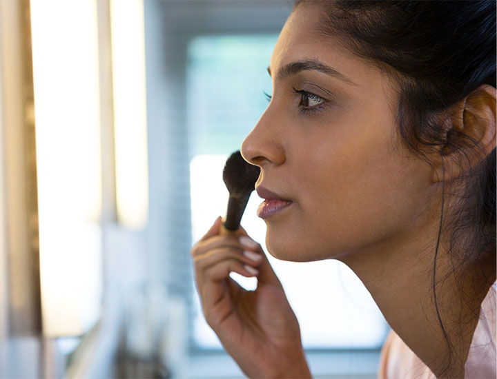 woman-applying-face-makeup