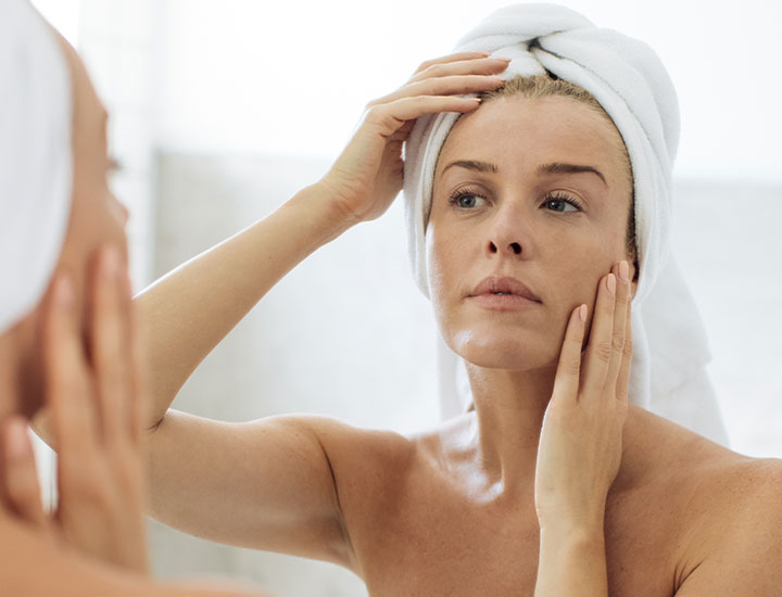 woman-checking-face-mirror