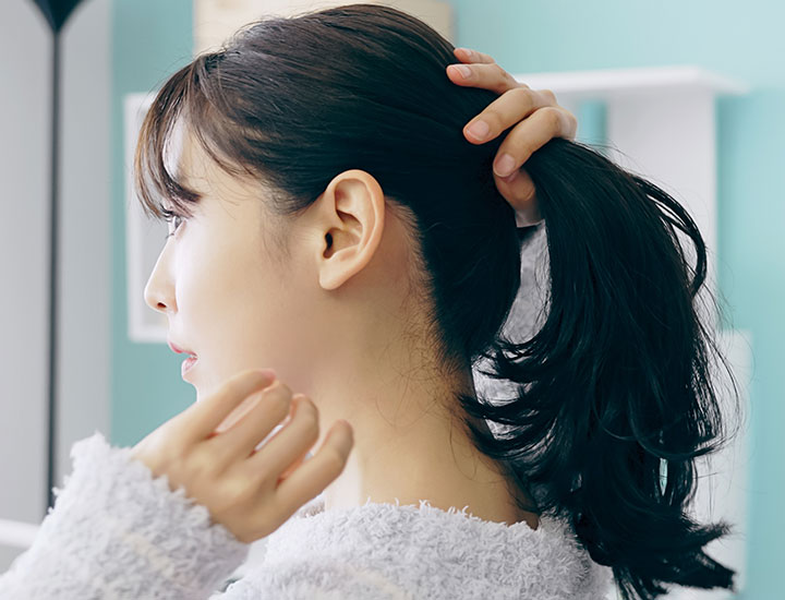 woman-tying-hair-ponytail