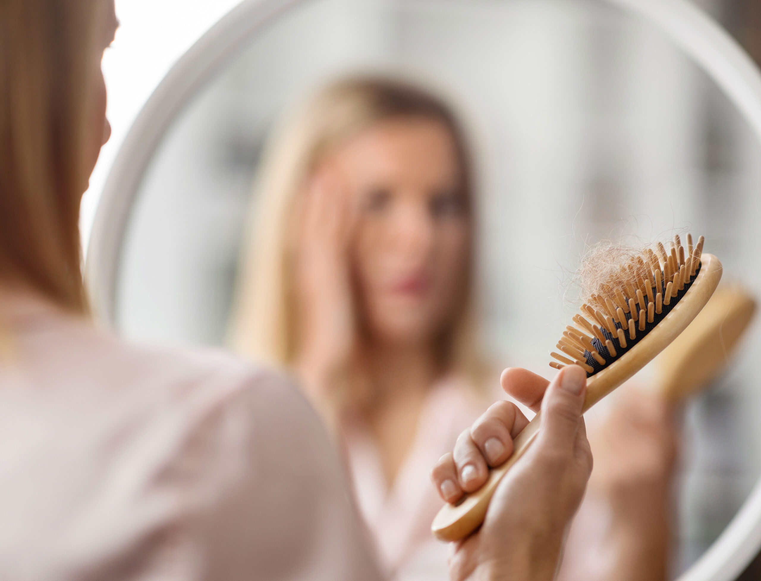 blonde-woman-holding-hair