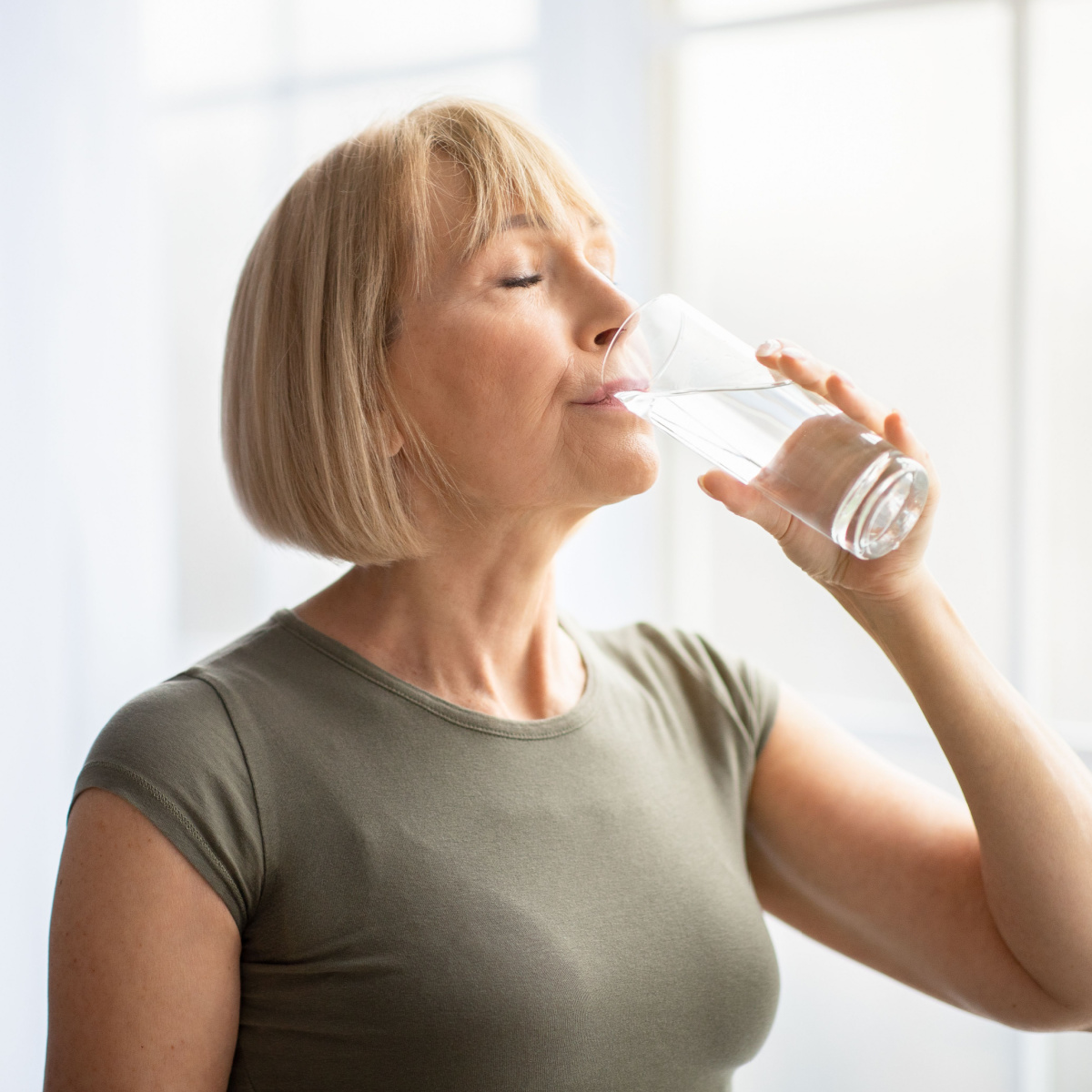 older woman drinking water