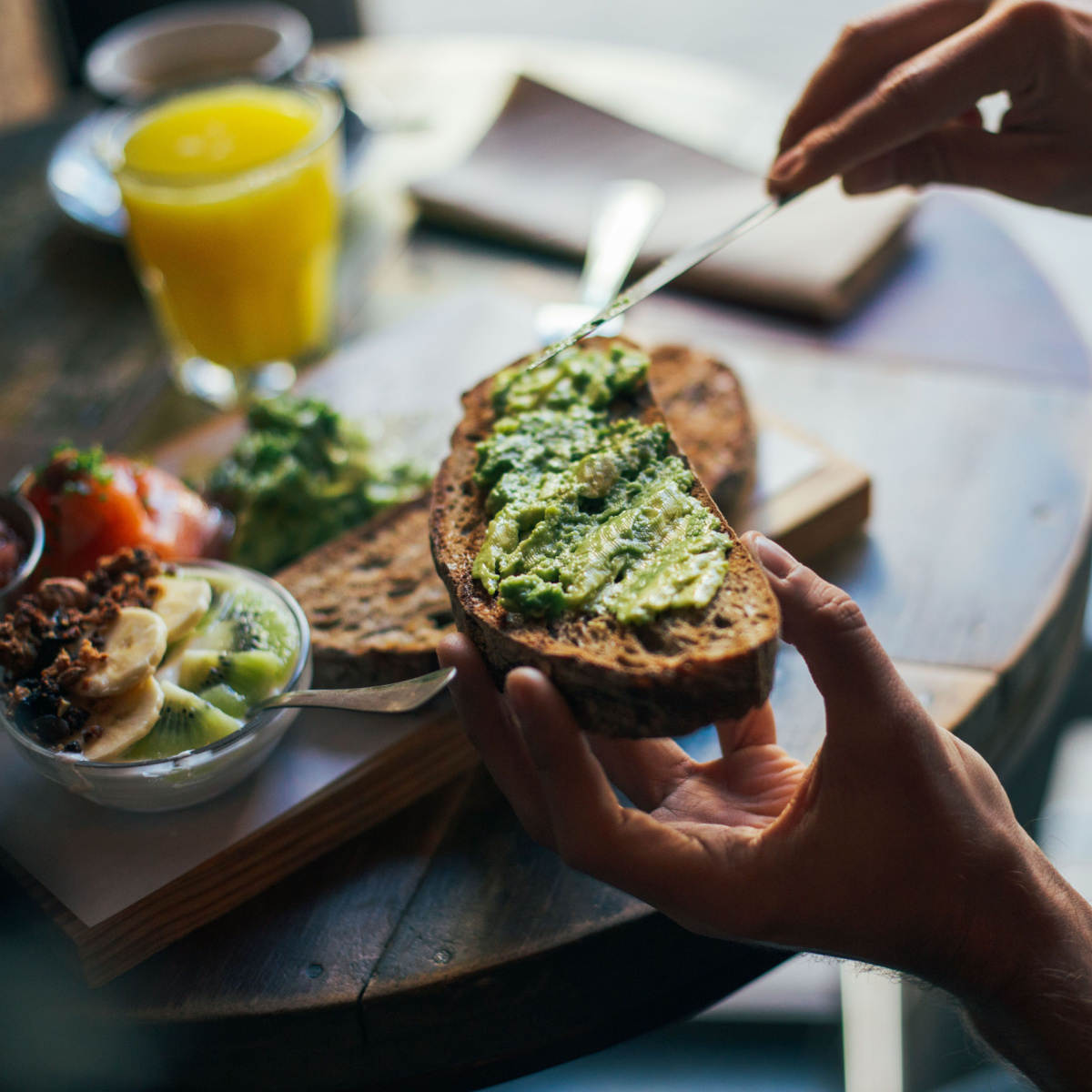 person making avocado toast