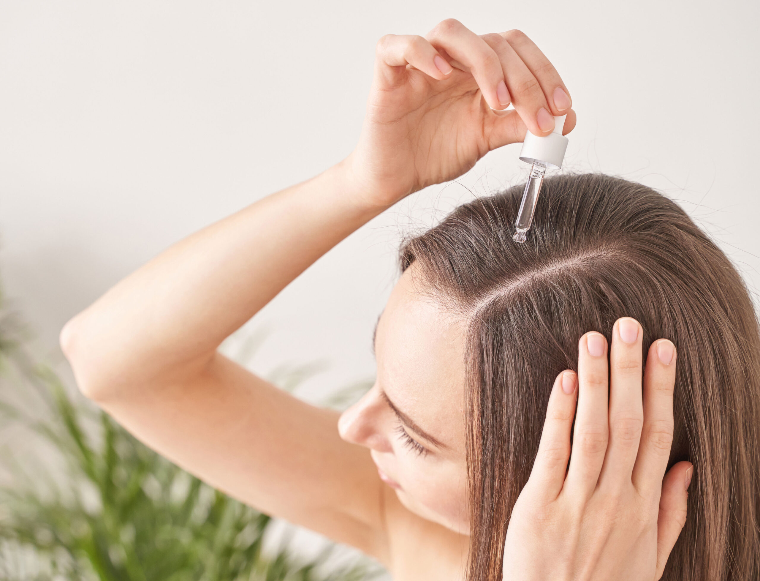 woman-applying-argan-oil-scalp