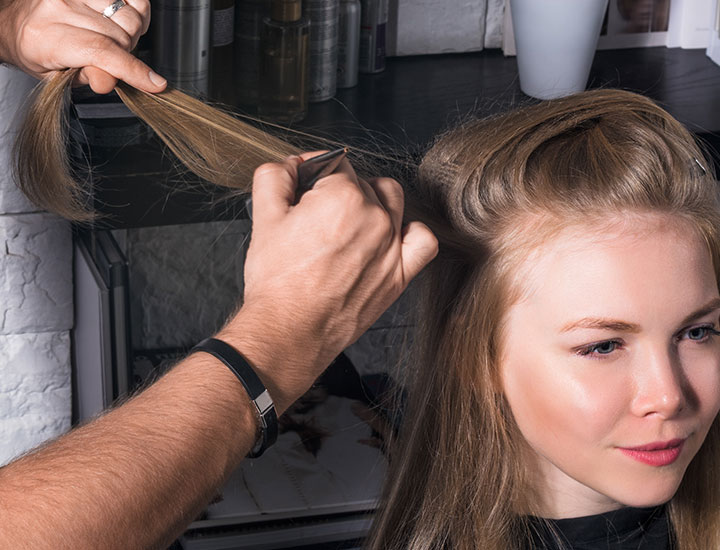 stylist-teasing-womans-hair