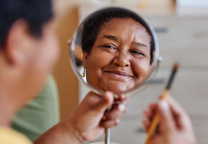 older-woman-smiling-mirror