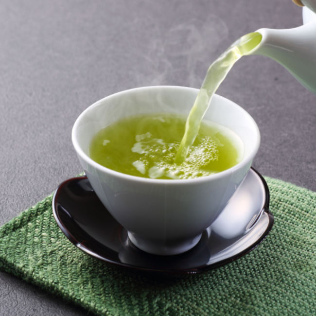 green tea pouring into cup