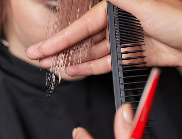 woman-getting-hair-trimmed