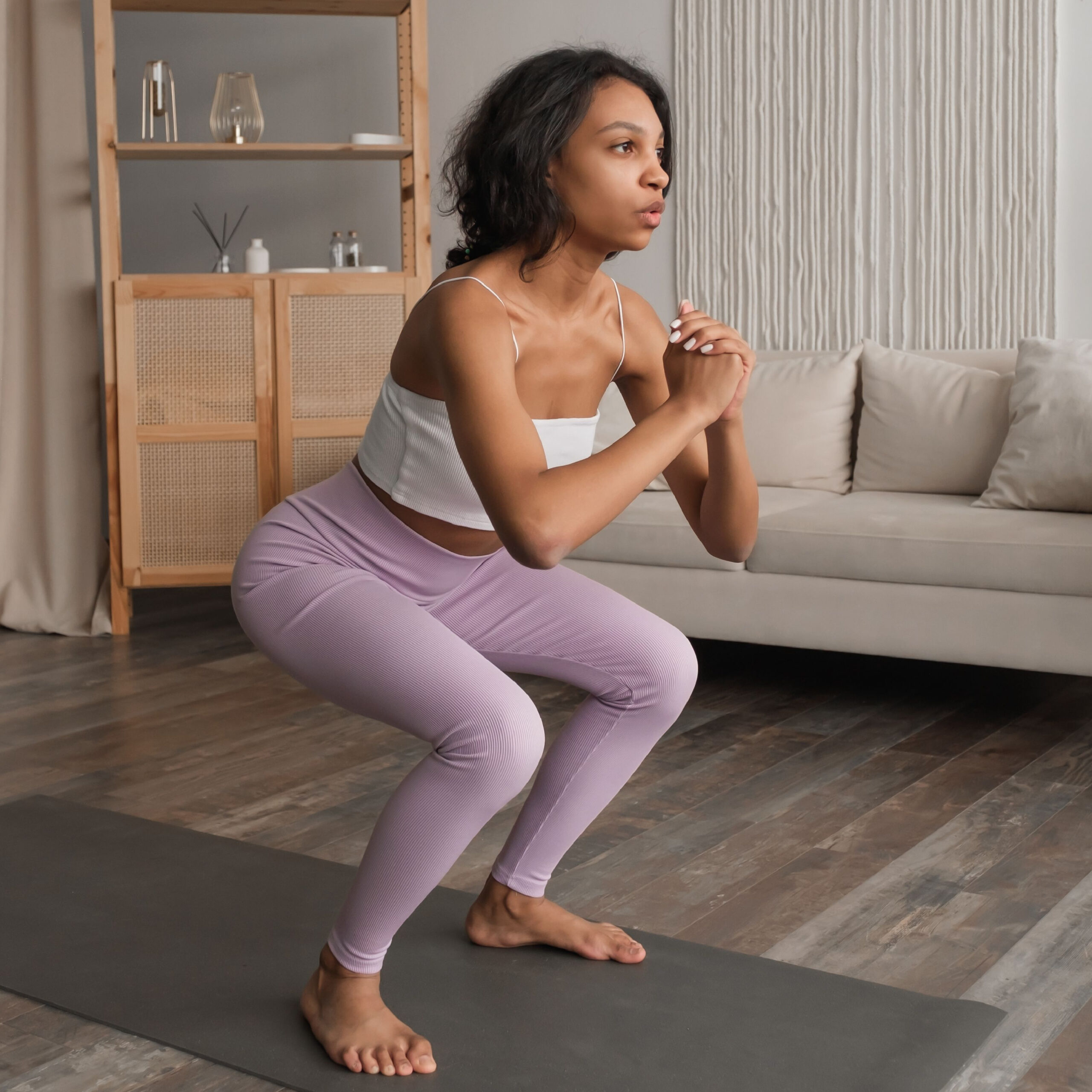 woman doing squats at home