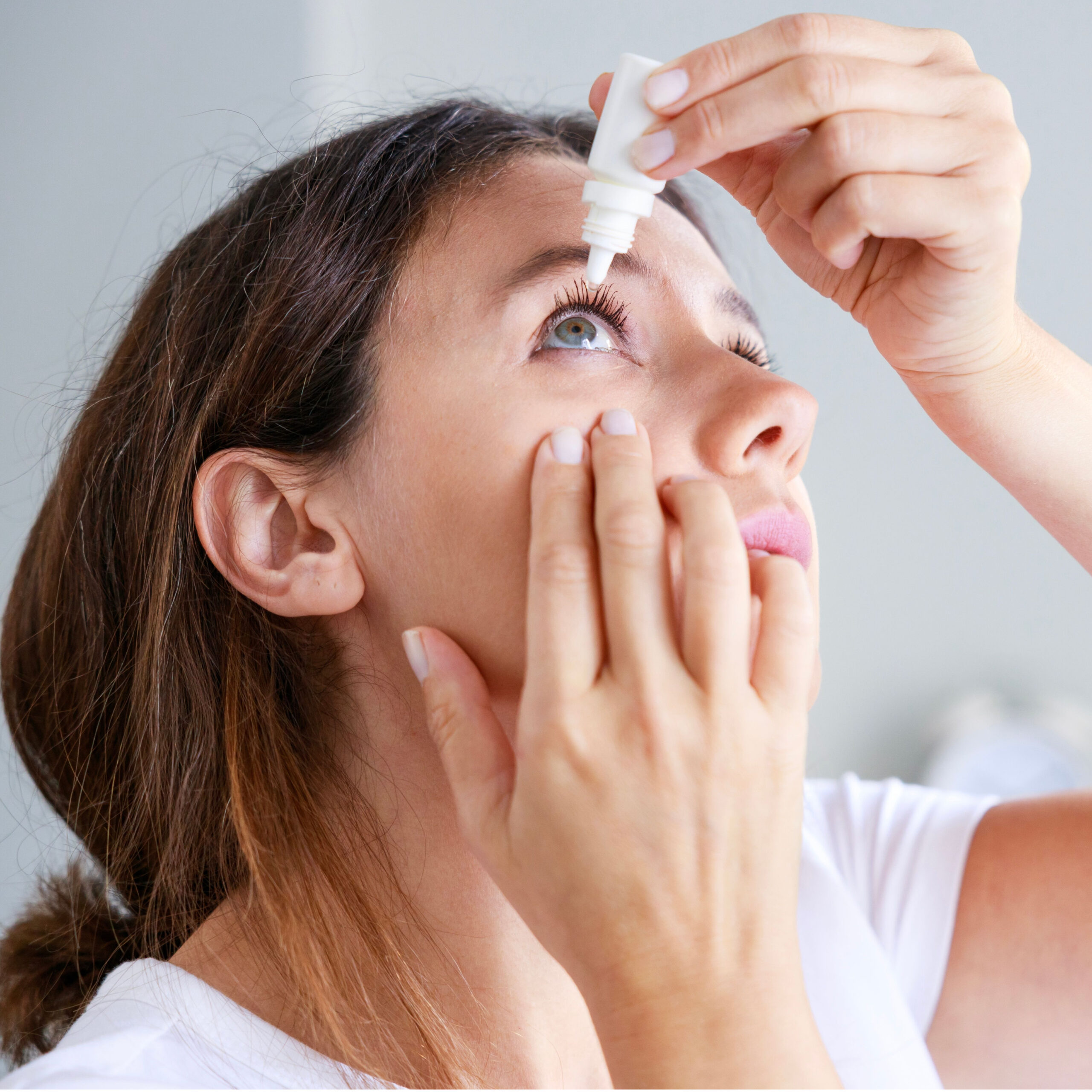 woman using eye drops