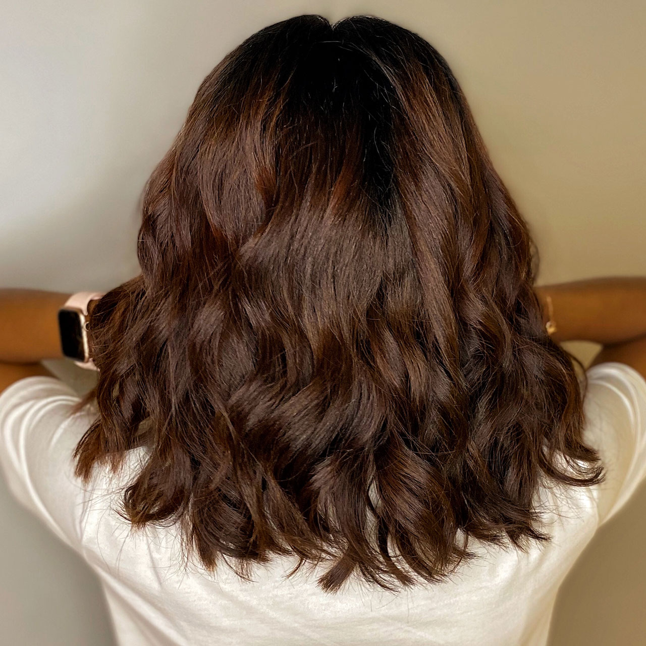Back Of Womans Wavy Brunette Shoulder Length Hair 