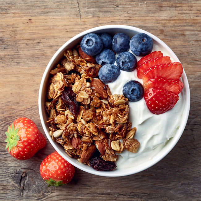 greek yogurt bowl topped with berries and granola