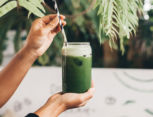 woman drinking green juice