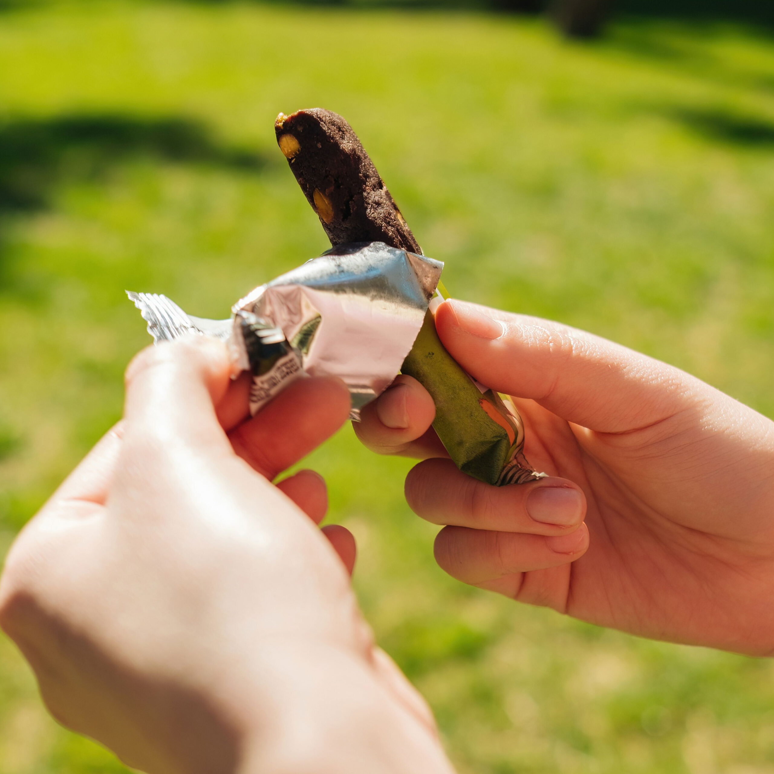 person opening protein bar