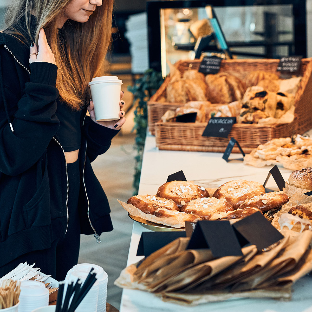 woman looking at breakfast pastry selection