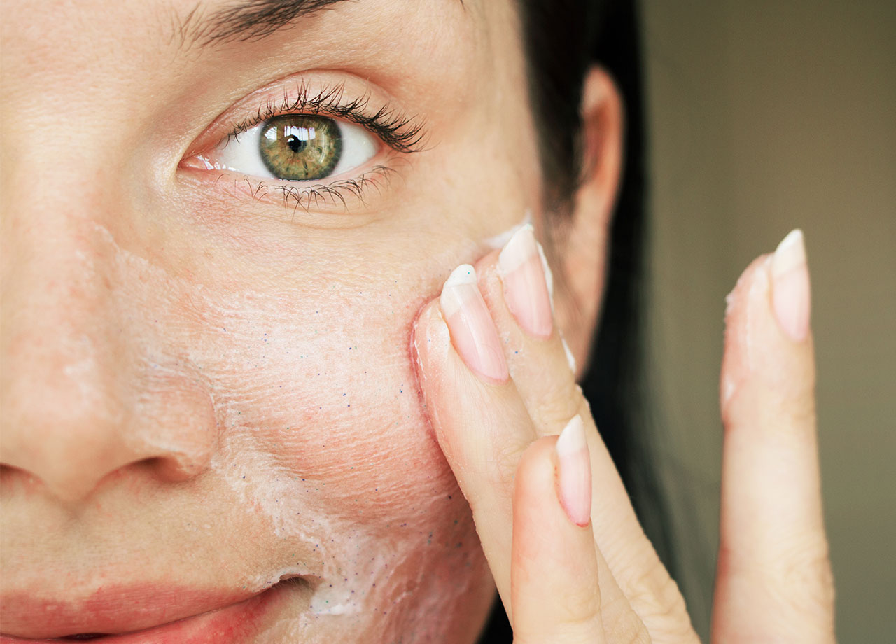 woman-moisturizing-face