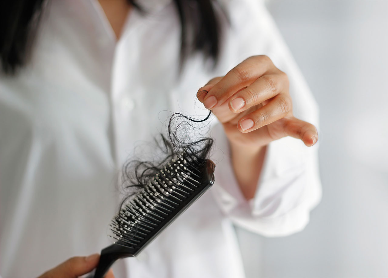 woman-pulling-hair-brush