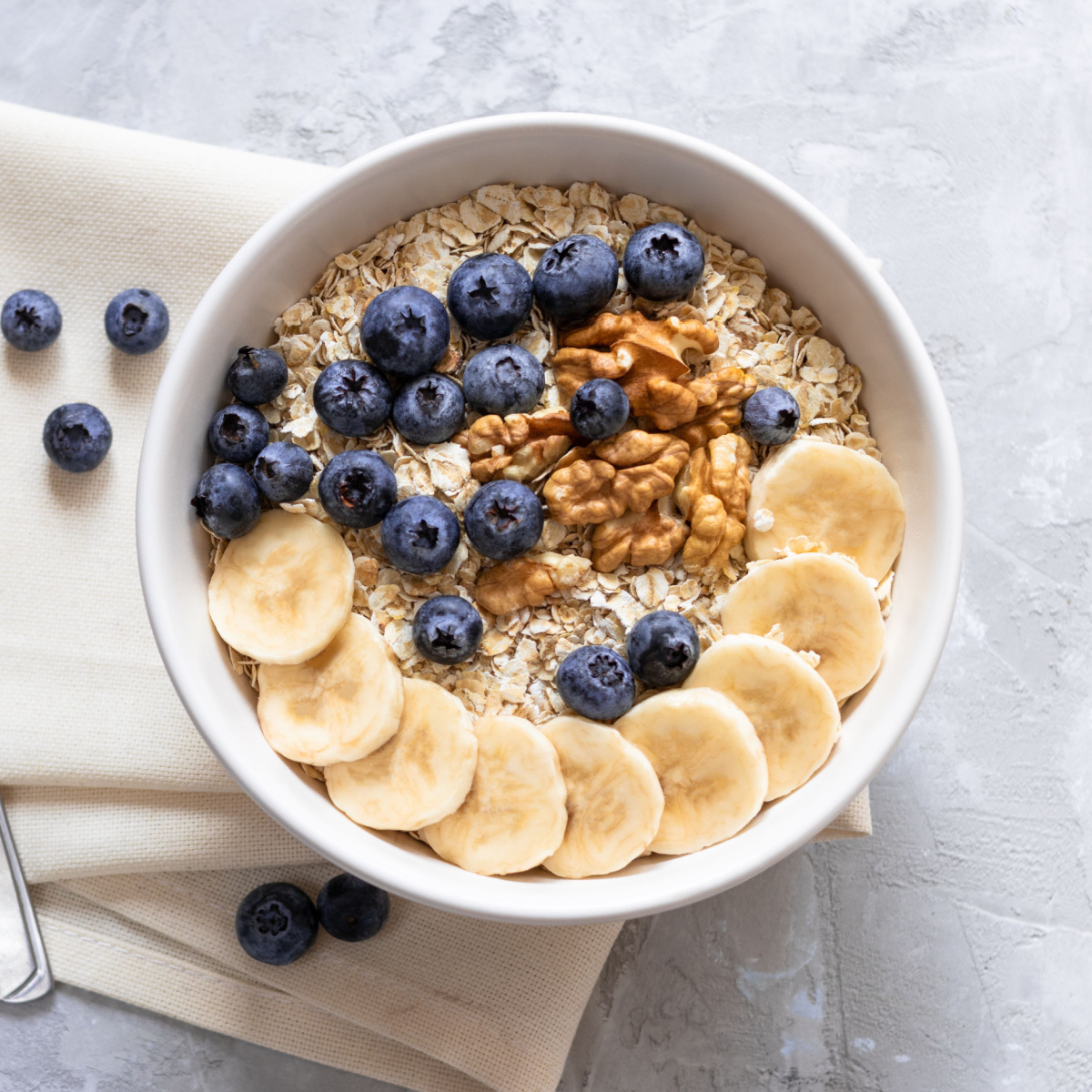 bowl of oatmeal with fruit and nuts