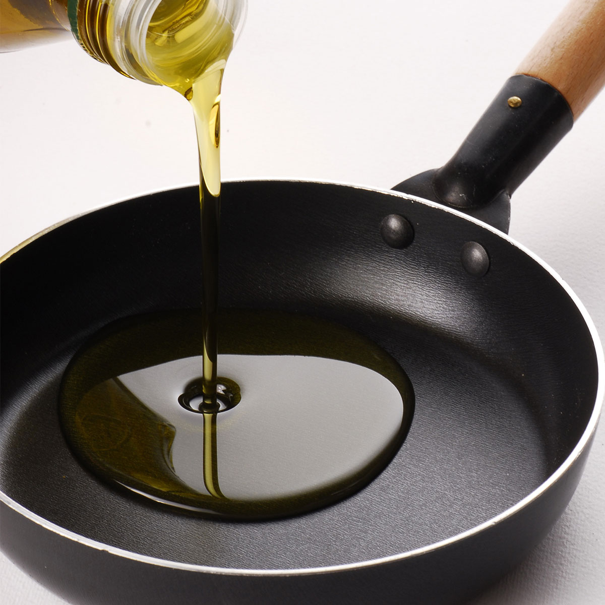 cooking oil pouring into pan