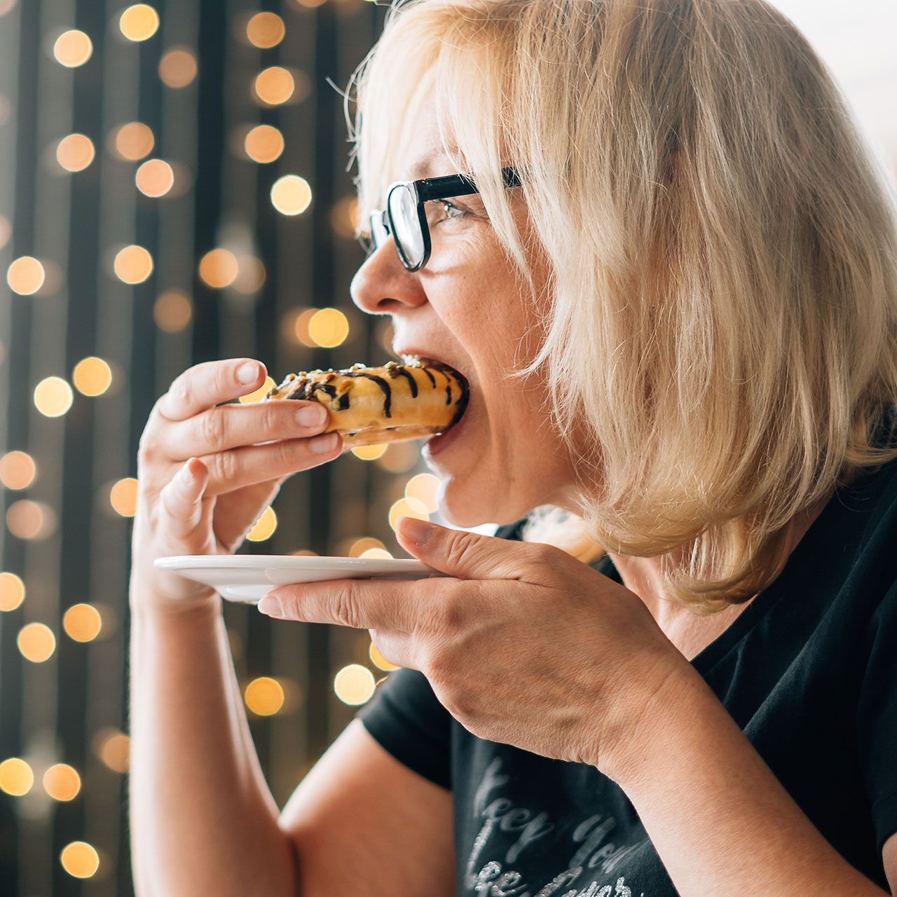 https://www.shefinds.com/files/2024/01/older-woman-eating-a-donut-dessert.jpg