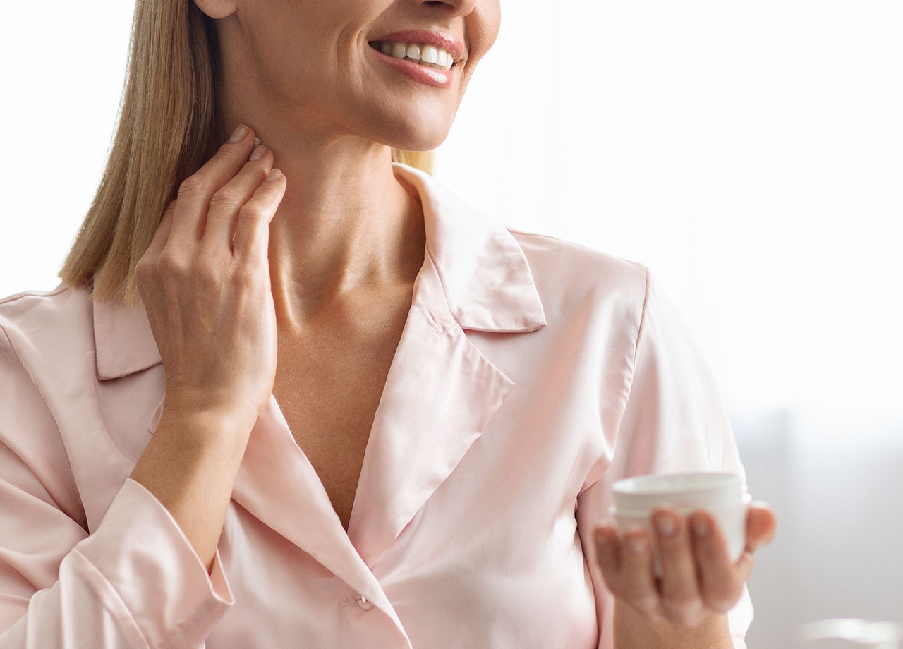 woman-applying-neck-cream