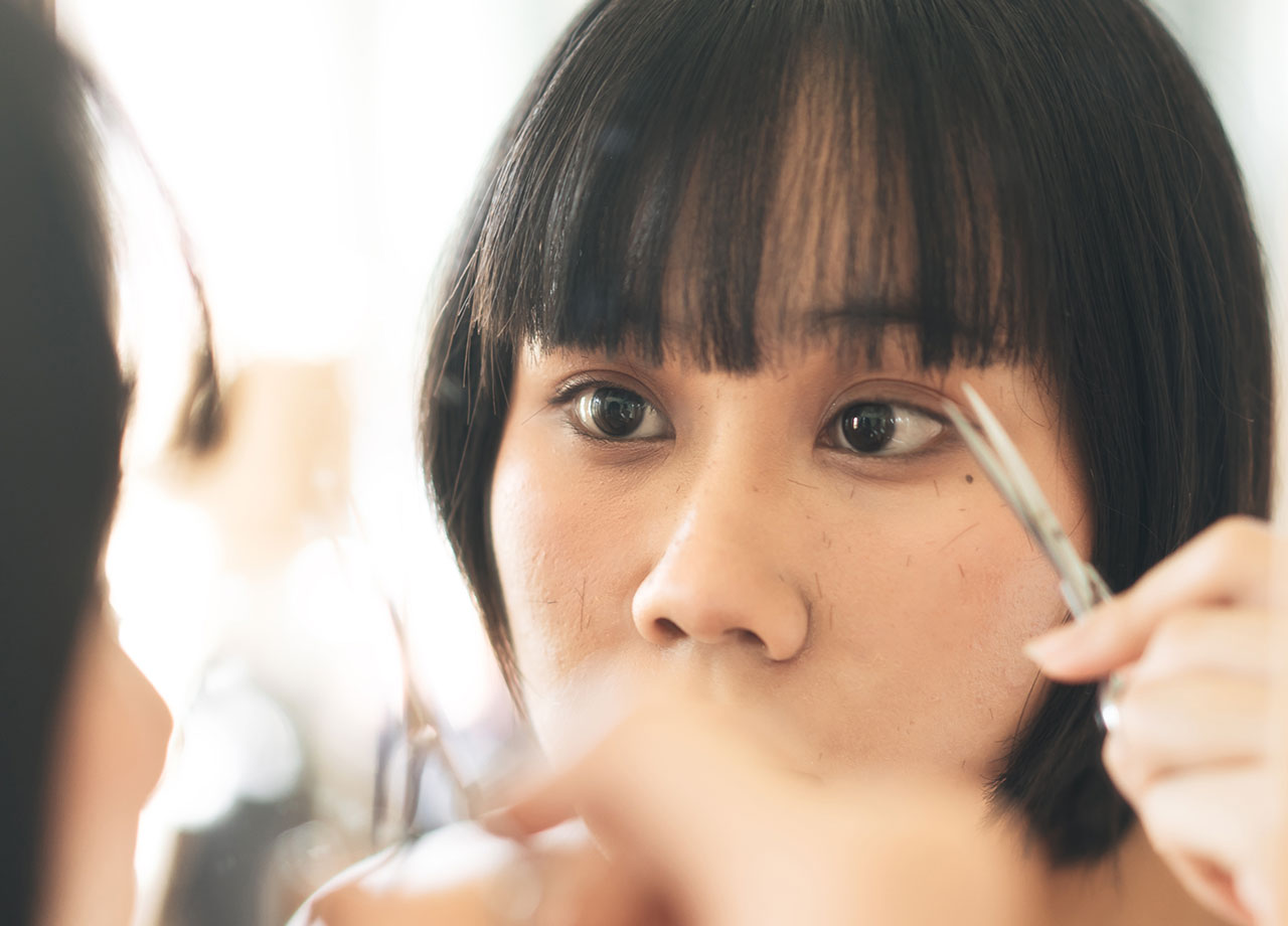 woman-cutting-blunt-bangs