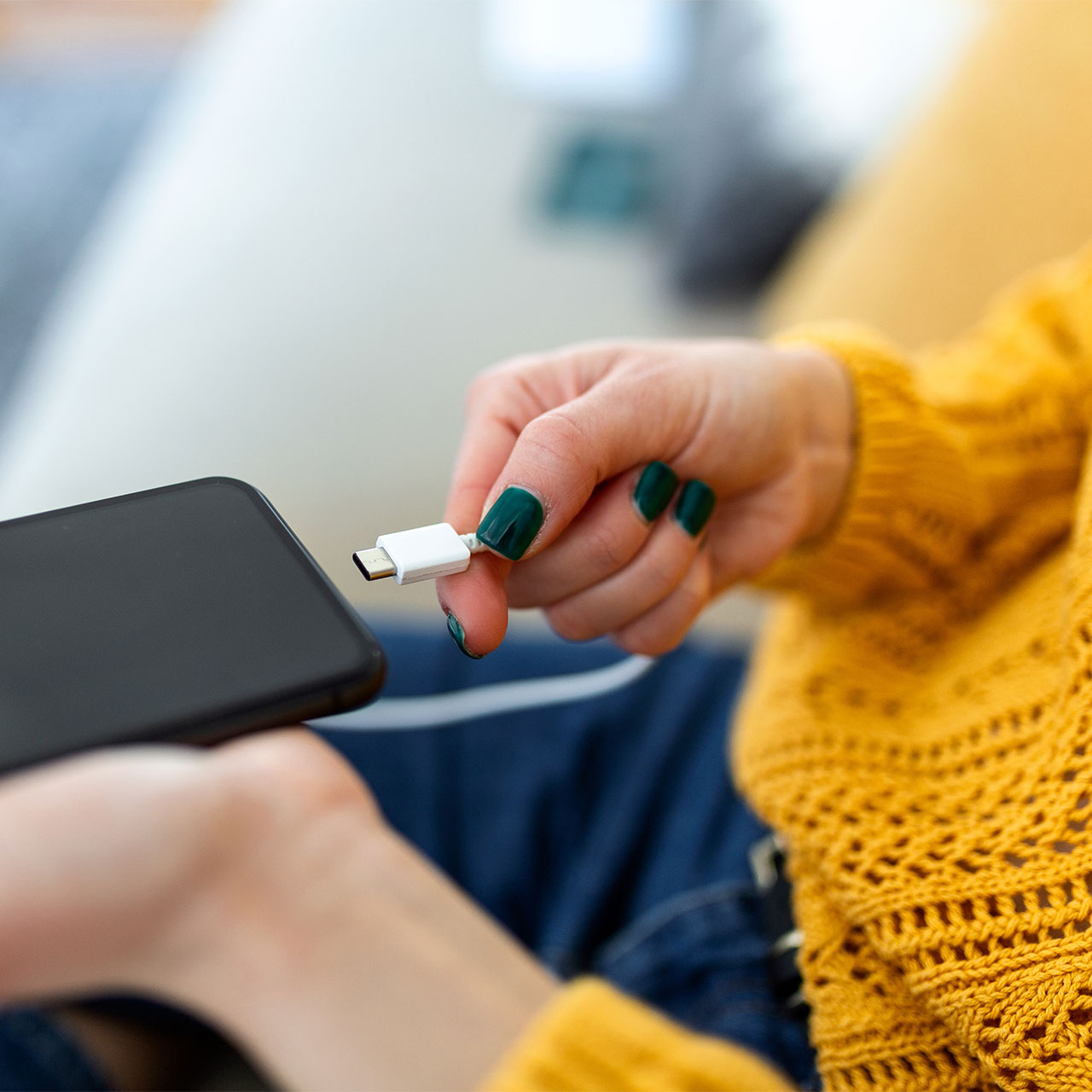 woman-plugging-iphone-charger