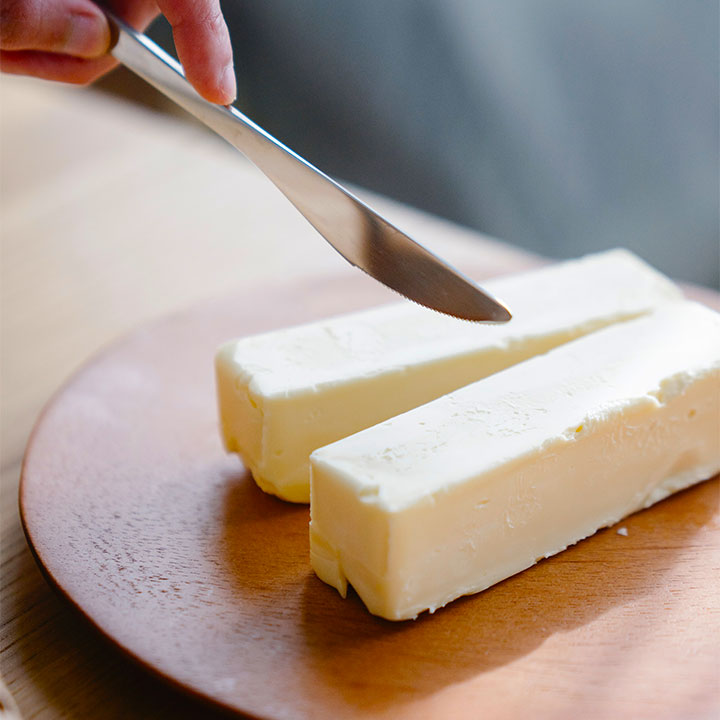 butter knife cutting two sticks of butter