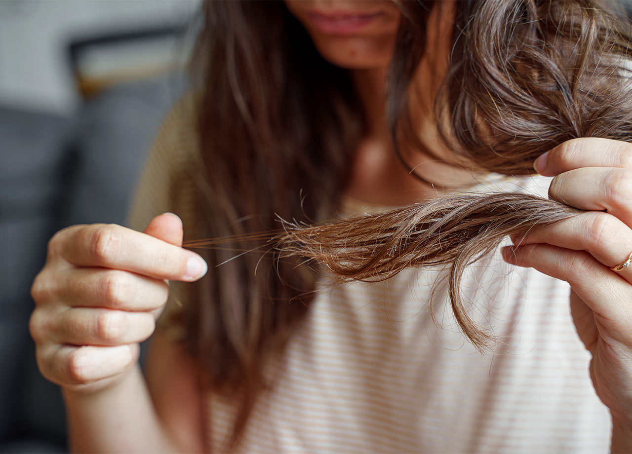 woman-playing-with-damaged-hair