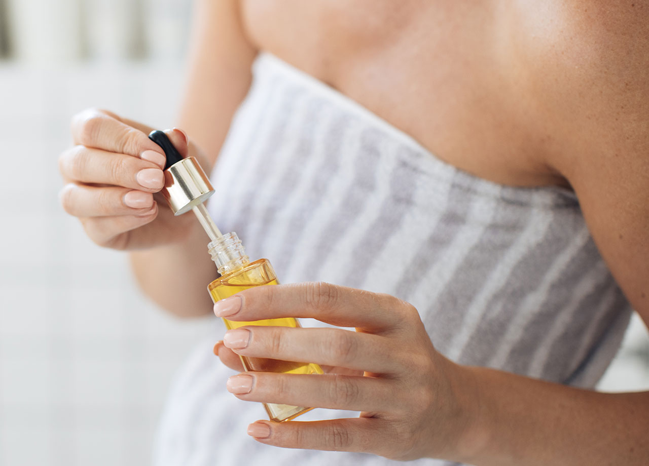 woman-with-skincare-bottle