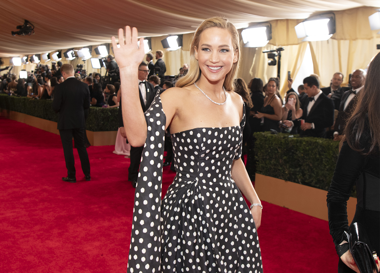 Jennifer Lawrence polka dot Dior gown waving 2024 Oscars